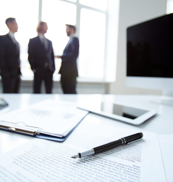 For business Business devices and documents at workplace, unrecognized businesspeople sharing ideas on background