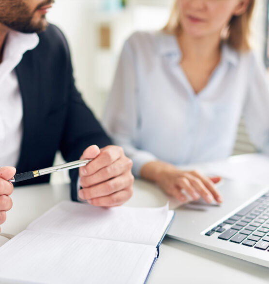 Discussing business plan Hands of businessman with pen over open notebook during interaction with colleague